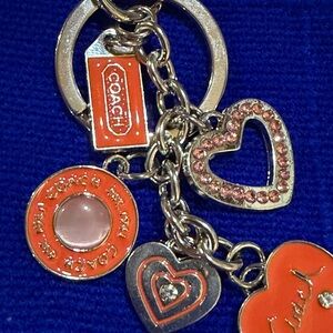 Orange and Gold Heart Charm Keychain. Charm says “Coach”